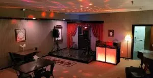 DJ services in Maine setup with red uplighting and dance floor at an event venue