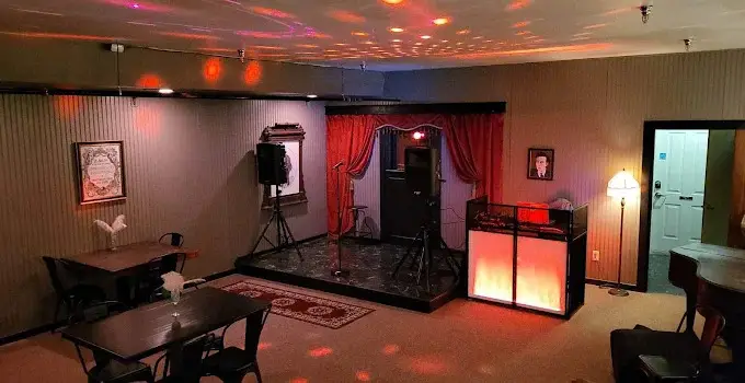 DJ services in Maine setup with red uplighting and dance floor at an event venue