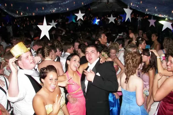 A Group Of Students Dressed In Formal Attire, Enjoying Their Semi Formal Maine School Dance.